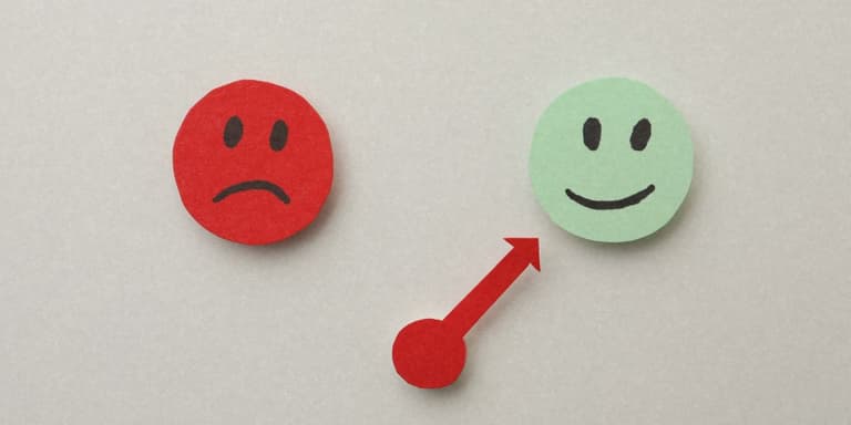 Zwei Smileys und ein Pfeil die ein Gefühls-Barometer darstellen.